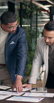 Meeting, chart and business men with documents for finance review, investment and budget planning. Office, talking and people with graph, paperwork and research for financial report, profit or growth