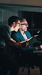 Night, office and businessman with assistant on tech for feedback, proposal update and finance report. Corporate, deadline and manager with help for financial review, investment or planning for audit