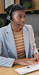 Consultant, computer or black woman with headset in office for online advice or customer service. Female person, agent or typing with smile or mic for virtual assistance, support or help in workplace