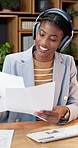 Business, documents and black woman with headphones in office for music, audio streaming or tasks. Happy, female person or employee working with smile for podcast, song playlist or app in workplace