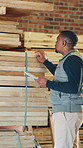 Carpenter, inspection and man with plank, tablet and inventory for quality assurance in workshop. Carpentry, woodworking and African person on tech for stock, timber production or material evaluation