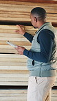 Carpenter, evaluation and man with wood, tablet and inventory for quality assurance in workshop. Carpentry, woodworking and African person on tech for review, timber production or material inspection