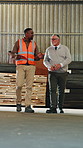 Carpentry, team and walk in warehouse with clipboard, manager inspection or stock control supervisor. Carpenter, men and discussion in factory with checklist, inventory management and collaboration.