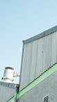 Sky, outdoor and roof of warehouse with building for factory, dropshipping and supply chain storage. Industrial, property and low angle with exterior for commerce, architecture and surface structure