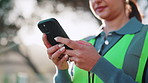 Phone, woman and hands of construction worker on site with email for feedback on building renovation. Technology, typing and civil engineer outdoor with cellphone for update on repairs or maintenance
