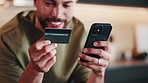 Credit card, phone and man in kitchen for online shopping, food purchase and internet order. Typing, home and male person on mobile app with debit info for ecommerce, subscription and web discount