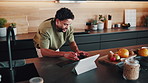 Happy man, tablet and typing in home for remote work, notes or article with editing and productivity. Freelancer, tech and writing for email feedback, proofreading and workflow for creative report
