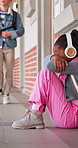 Thinking, sad or girl at elementary school with headphones, anxiety or child trauma in past memory. Mental health, nerves or kid on ground with technology, bad flashback or loneliness at academy.