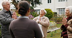Meditation, coach and senior friends outdoor with calm, peace and mindfulness in morning. Prayer hands, health club and group of elderly people in backyard of retirement home for wellness on weekend.
