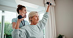 Physiotherapy, support and senior woman with dumbbells, physiotherapist and talking for advice. Help, healthcare and wellness with old patient at clinic for exercise, weights and rehabilitation