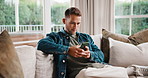 Text, message and man on sofa with phone, web search and online chat on social media app. Contact, reading and person in house with tech, internet browse and digital communication on virtual platform