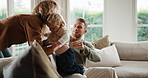 Parents, baby and man in home with tablet, reading ebook and browsing website for childcare break. Mother, carry child and person relax in living room with tech, internet or time off from dad duties.