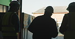 Logistics, people and walk outdoor by warehouse with discussion, distribution and shipping feedback. Back, team and meeting by factory with conversation, supply chain management and collaboration.