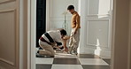 Dad, child and tying shoes in home for outing, holiday trip or weekend preparation together. Mom, father and getting ready with son, sneakers or parenting for house departure, travel or vacation