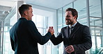 Business, people and meeting in office with handshake, greeting and thank you for partnership. Smile, men or shaking hands in workplace with friendly hug, introduction and respect for b2b onboarding 