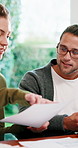 Smile, couple and paperwork in home for finance, expenses or asset management with taxes. Happy man, woman and discussion with budget document, investment savings or point for solution with laptop 