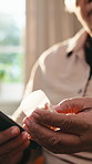 Phone, pills and hands of senior person for side effects, research and medicine for arthritis. Healthcare, cellphone and woman with medication ingredients, tablet info and website for prescription
