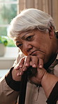 Senior, woman and thinking with cane in retirement home for nostalgia, daydreaming or reminisce. Thoughtful, elderly or female person with walking stick for vision, past moment or memory in house