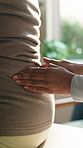 Nurse, patient and hands with back massage for physiotherapy or pain relief in private practice. Chiropractor, doctor or spine with injury, discomfort or muscle tension for rehabilitation in clinic