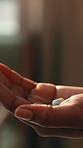 Home, health and hands of person with pills for treatment, antibiotics and medicine for recovery. Healthcare, house and woman with medication, tablets and capsule for prescription, wellness and cure