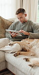 Relax, tablet and man with dog on sofa for bonding, trust and chill with internet on weekend. Smile, home and person with Golden Retriever, stroke and petting on tech for website, connection or happy