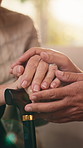 Consoling, hands and walking stick with senior person in retirement home for care or support. Balance, cane and empathy with people closeup in apartment together for consulting, solidarity or trust