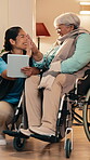 Caregiver, high five and senior woman with wheelchair for support, medical healthcare and tablet. Smile, nurse and person with disability for retirement, tech and checkup success with celebration
