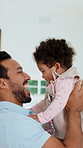 Father, laugh and lift baby in home with kiss, bonding and support for early childhood development. Happy, man and play in living room with infant daughter, affection and parent care for wellness.