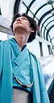 Escalator, thinking and yakata with Japanese man in city for commute, journey or traditional clothes. Culture, ideas and travel with Asian person outdoor in urban town for break, trip or vision