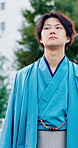 Thinking, walking and yakata with Asian man outdoor for commute, journey or traditional clothes. City, culture and ideas with thoughtful Japanese person in urban town for break, travel or vision