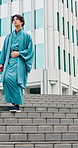 Steps, thinking and yakata with Asian man in city for commute, journey or traditional clothes. Culture, ideas and stairs with Japanese person walking outdoor in urban town for break, trip or vision