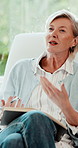 Notebook, talking and woman counselor on sofa for advice, mental health or wellness feedback. Conversation, discussion and review with mature therapist in office for healing, help or psychology