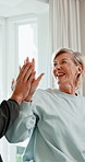 Physiotherapy, stretching and mature woman with high five for rehabilitation, healing and fitness. Professional man, patient and support with resistance band, physio and celebrate success at clinic