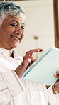 Happy, thinking and senior woman with tablet in home with research, communication or reading blog. Smile, tech and elderly person in retirement with online article on pension planning from below.