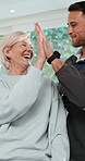 Physiotherapy, dumbbells and mature woman with high five for rehabilitation, healing and fitness. Celebrate success, patient and consultation with weights, physio and muscle wellness at clinic