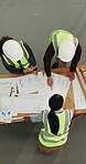 Above, construction site and people with blueprint at job, strategy and productivity for collaboration. Team, building progress and floor plan with discussion for property development and renovation
