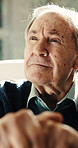 Thinking, cane and elderly man in home for reflection, nostalgia and memory in retirement. Closeup, thoughtful and pensioner with walking stick for balance, support and wellness for assisted living