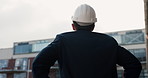 Back, helmet and engineer in city for construction safety, real estate development or thinking. Man, ppe and contractor outdoor for building inspection, compliance planning or property expansion