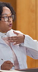 Doctor, woman and hello with video call for healthcare, consultation and notes for symptom discussion. Mature, happy physician and virtual meeting for medical help, waving or greeting for Telehealth