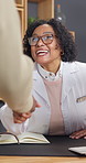 Doctor, woman and handshake with patient in office for prescription or medical consultation. Female person, healthcare worker or shaking hands with client for health diagnosis or pharmaceuticals