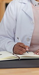 Woman, doctor and hands writing with book in clinic office for medical prescription or diagnosis. Female person, healthcare worker or taking notes with diary or notebook for health consultation