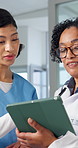 Discussion, doctor and nurse with tablet for medical mentorship, patient report or team schedule. Tech, women and talk in healthcare clinic with intern for training, advice and planning with flare