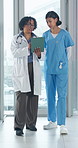 Medical team, talking or walk with tablet in hospital for feedback, insurance records or schedule. Tech, women and planning with healthcare nurse, doctor and diagnosis collaboration for clinical case