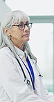 Mature, thinking and doctor in hospital with stress, overwhelmed and burnout for healthcare. Frustrated, lobby and woman with reflection, worry and fatigue for medical crisis, career and pressure