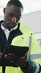 Architect, maintenance and man with tablet in building for quality control with renovation schedule. Serious person, development and tech for construction log, evaluation or typing report at site