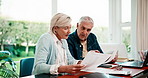 Senior, couple and finance with paperwork in home for income mapping, utility bills or discussion. Marriage, people or invoice on laptop for household expenses, retirement annuity or explain on flare