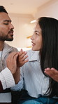 Couple, conversation and stress in home with fight, argument and upset girlfriend ready for breakup. People, talk and conflict in living room with toxic relationship, drama and boyfriend apologize.