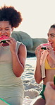 Picnic, happy and friends with watermelon on beach for summer vacation, getaway or weekend trip. Smile, sunglasses and people eating fruit for healthy snack by ocean for holiday, relax or travel.