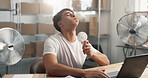 Logistics, laptop and man with fan for hot weather, heatwave and cool down with air flow in office. Computer, person and heat stress, summer fatigue and humidity problem in distribution startup