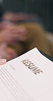 Hands, person and resume in waiting room for hiring process, review career history or info recall. HR office, candidate or cv for experience revision, recruitment or interview preparation for vacancy